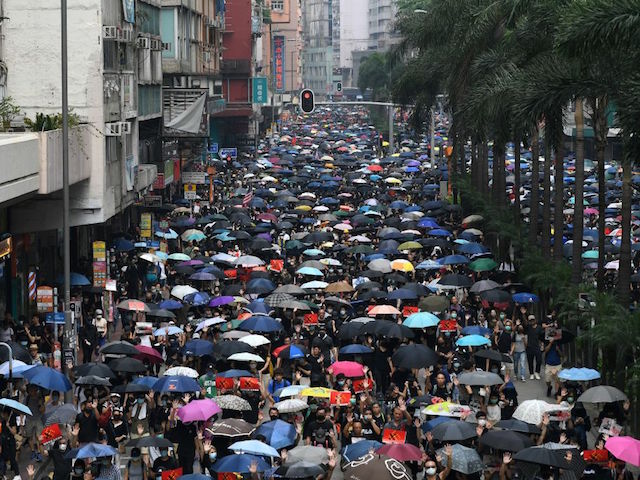 Thousands of people hold an unsanctioned march through the streets of Hong Kong on September 29, 2019, part a coordinated day of global protests aimed at casting a shadow over communist China's upcoming 70th birthday. - Hong Kong descended into a second day of clashes between pro-democracy protesters and riot police on September 29 as activists step up their nearly four months campaign ahead of the 70th anniversary of communist China's founding. (Photo by Mohd RASFAN / AFP) (Photo credit should read MOHD RASFAN/AFP/Getty Images)