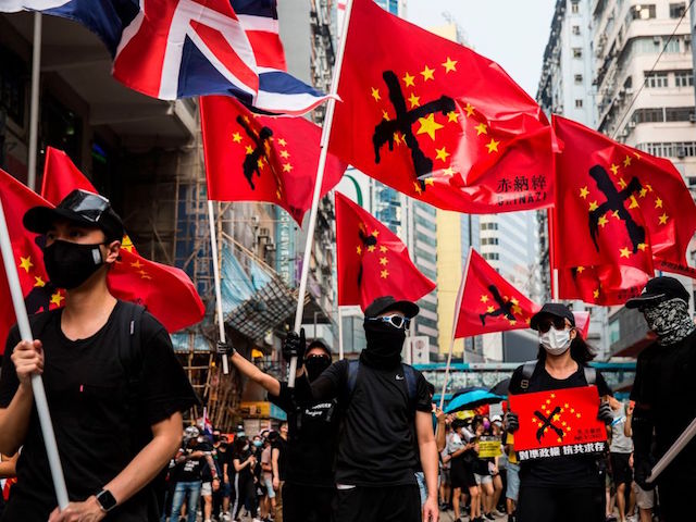 Thousands of people hold an unsanctioned protest march through the streets of Hong Kong on September 29, 2019. - Thousands of Hong Kongers defied police tear gas rounds on September 29 to hold an unsanctioned march through the city, part of a coordinated day of global protests aimed at casting a shadow over communist China's upcoming 70th birthday. (Photo by ISAAC LAWRENCE / AFP) (Photo credit should read ISAAC LAWRENCE/AFP/Getty Images)