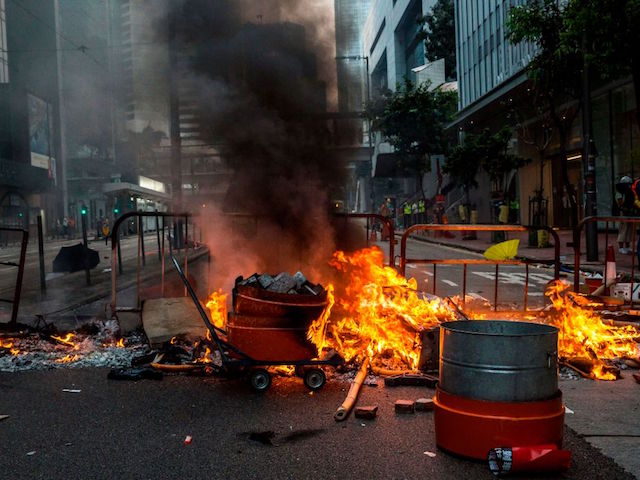 Debris are left burning during clashes with police following an unsanctioned march through Hong Kong on September 29, 2019. - Fierce clashes broke out between protesters and riot police in Hong Kong on September 29 as thousands marched through the strife-torn city, during a day of global protests aimed at casting a shadow over communist China's upcoming 70th birthday. (Photo by ISAAC LAWRENCE / AFP) (Photo credit should read ISAAC LAWRENCE/AFP/Getty Images)