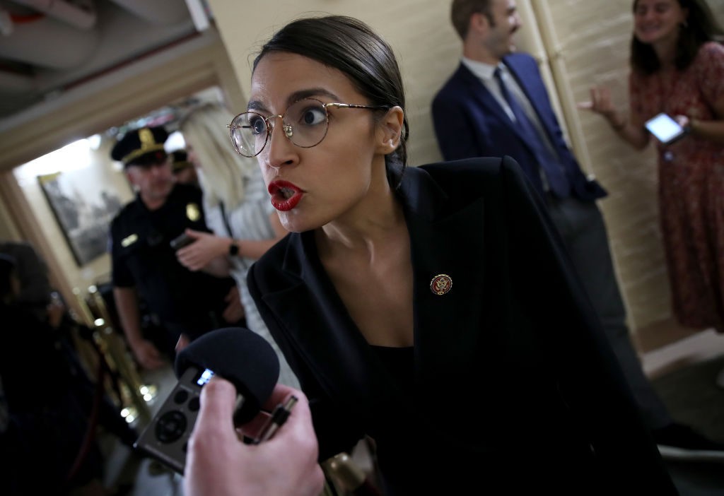 WASHINGTON, DC - SEPTEMBER 24: Rep. Alexandria Ocasio-Cortez (D-NY) answers questions from reporters while entering a House Democratic caucus meeting at the U.S. Capitol where formal impeachment proceedings against U.S. President Donald Trump were announced by Speaker of the House Nancy Pelosi September 24, 2019 in Washington, DC. Pelosi announced a formal impeachment inquiry after allegations that President Donald Trump sought to pressure the president of Ukraine to investigate leading Democratic presidential contender, former Vice President Joe Biden and his son, which was the subject of a reported whistle-blower complaint that the Trump administration has withheld from Congress. (Photo by Win McNamee/Getty Images)