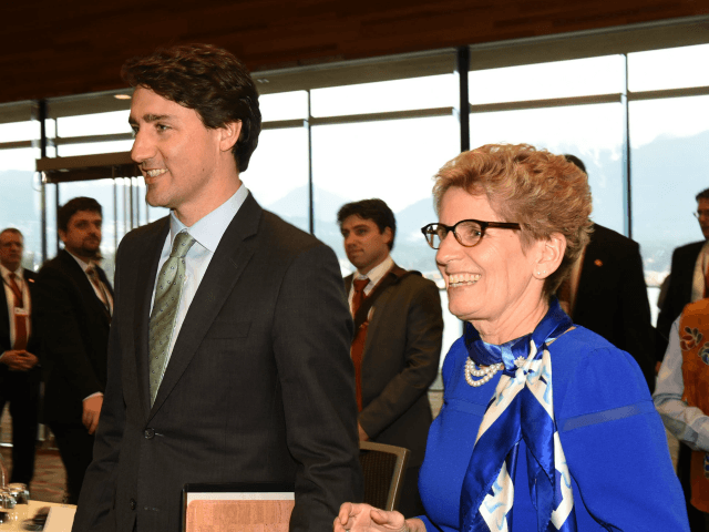 Prime Minister Justin Trudeau and Ontario Premier Kathleen Wynne arrive at the First Minis