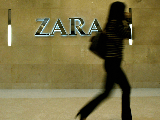 A woman walks past an outlet of the fashion chain Zara in Hong Kong, 29 November 2004. Ret