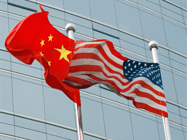 A US and a Chinese flag wave outside a commercial building in Beijing, 09 July 2007. US Secretary of State Condoleezza Rice 06 July 2007 accused China of flouting the rules of global trade in its headlong economic expansion as the US administration "has not been hesitant" to deploy trade …
