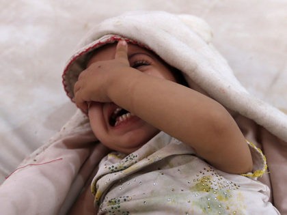 TOPSHOT - A yemeni child, who is suspected of being infected with cholera, cries at a hospital in the capital Sanaa, on August 12, 2017. A cholera outbreak has claimed the lives of some 2,000 Yemenis in less than four months. / AFP PHOTO / Mohammed HUWAIS (Photo credit should …
