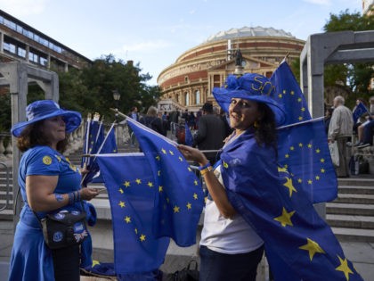 Pro-EU demonstrators activists hand out EU flags to concert goers outside the Royal Albert Hall in London on September 9, 2017 ahead of the Last Night of the Proms concert. Activists distributed EU flags in an anti-Brexit demonstration to concert goers outside the venue of the annual Last Night of …