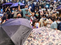 High-school students and residents take part in a singing event in a shopping mall after a human chain rally in Tsuen Wan district in Hong Kong on September 20, 2019. - Amnesty International on September 20 accused Hong Kong police of using excessive force against pro-democracy protesters, in some cases …