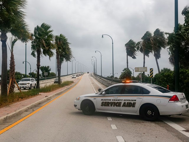 Authorities block a road in Jensen Beach, Florida on September 2, 2019. - Monster storm Do