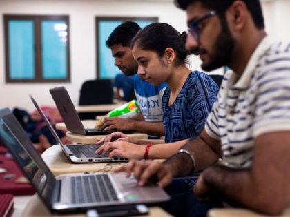 Indian undergraduate students code on their computers as they take part in HackCBS, a 24 h