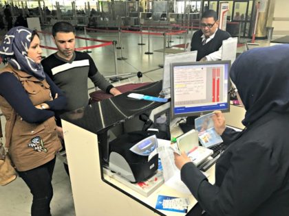 Samah Yousef, second from left, and his wife, Mariam Ali, left, Iraqis who were prevented from boarding a flight to United State a few days ago, prepare to board a flight bound for Egypt on Monday, on their way to the United States in Baghdad airport, Iraq, Monday, Feb. 6, …