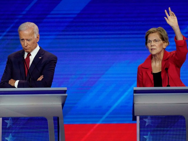 Former Vice President Joe Biden, left, and Sen. Elizabeth Warren, D-Mass., right, Thursday, Sept. 12, 2019, listen during a Democratic presidential primary debate hosted by ABC at Texas Southern University in Houston. (AP Photo/David J. Phillip)
