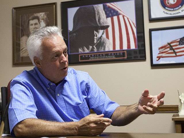 In this Aug. 9, 2011 photo, Johnny Spann talks with reporters in his Winfield, Ala., real