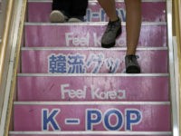 In this Aug. 13, 2019 photo, visitors walk down the stairs at a shop selling South Korean goods in Shin Okubo area in Tokyo. Tokyo’s Shin Okubo district bustles with Korean restaurants and stores selling K-pop merchandise. (AP Photo/Eugene Hoshiko)
