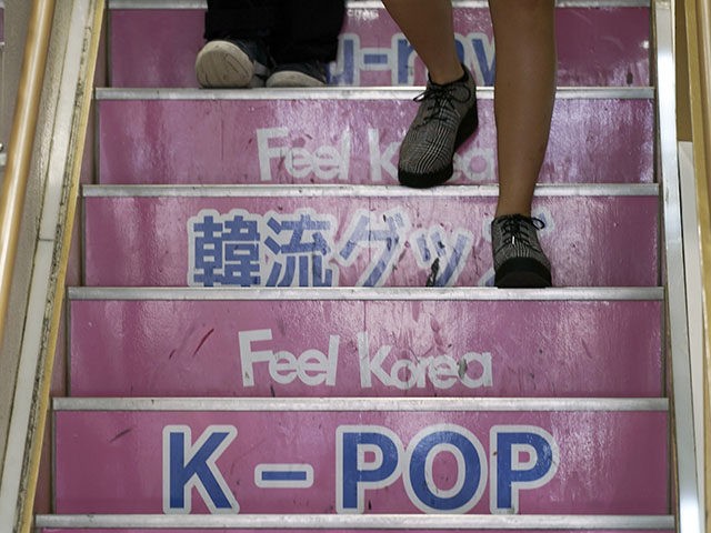 In this Aug. 13, 2019 photo, visitors walk down the stairs at a shop selling South Korean