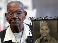 World War II veteran Lawrence Brooks holds a photo of him taken in 1943, as he celebrates his 110th birthday at the National World War II Museum in New Orleans, Thursday, Sept. 12, 2019. Brooks was born Sept. 12, 1909, and served in the predominantly African-American 91st Engineer Battalion, which …