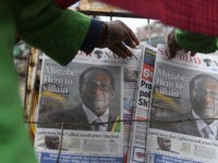 A man buys a daily newspaper at a stand on the streets of Nairobi, on September 7, 2019, following the death of former Zimbabwe president Robert Mugabe, guerrilla hero turned despot who ruled Zimbabwe for 37 years. - Mugabe, 95, passed away on September 6, 2019 in Singapore, where he …