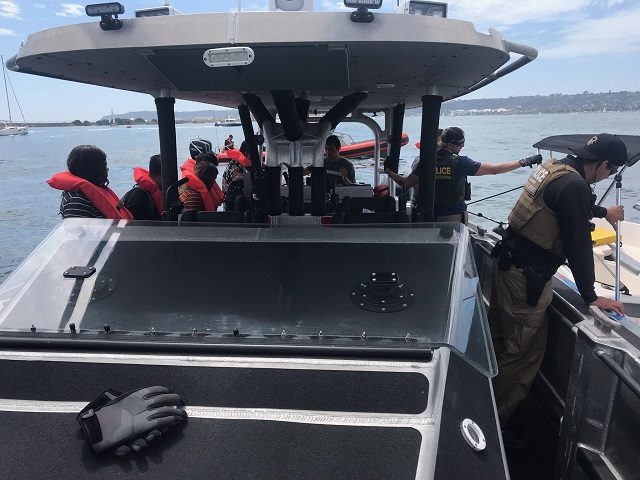 CBP officers and a Border Patrol agent rescue nine people from a sinking boat in San Diego