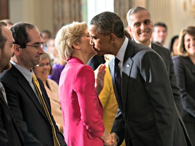 US President Barack Obama leans in to kiss Senator Elizabeth Warren (D-MA) after making a