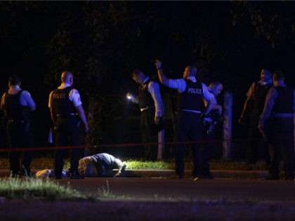 Chicago Police officer investigate the crime scene where a man was shot and killed on the