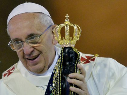 Pope Francis holds an iimage of Our Lady of Aparecida during the Holy Mass at the National Shrine of Our Lady of Aparecida, in Aparecida, state of Sao Paulo, on July 24, 2013. Pope Francis warned Catholics on Wednesday against "ephemeral idols" like money at his first public mass in …