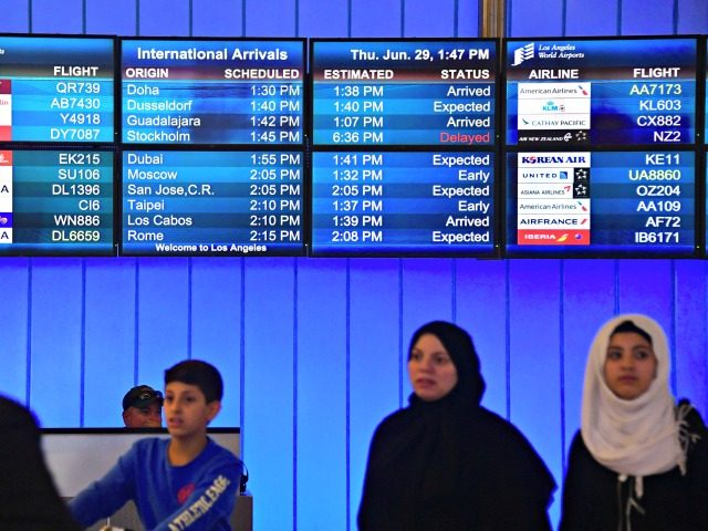 Travellers from the Middle East exit the International Arrivals section at Los Angeles Int