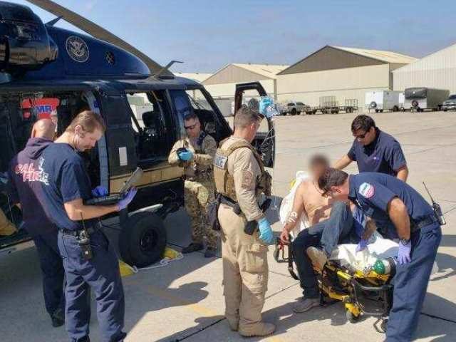A San Diego Sector Air and Marine Operations aircrew and Border Patrol agents team up to rescue a migrant suffering from heat and dehydration. (Photo: U.S. Customs and Border Protection/San Diego Sector)