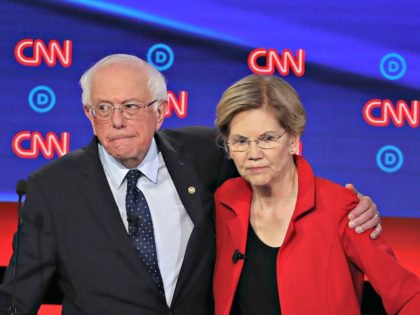 DETROIT, MICHIGAN - JULY 30: Democratic presidential candidate Sen. Bernie Sanders (I-VT) (L) and Sen. Elizabeth Warren (D-MA) embrace after the Democratic Presidential Debate at the Fox Theatre July 30, 2019 in Detroit, Michigan. 20 Democratic presidential candidates were split into two groups of 10 to take part in the …