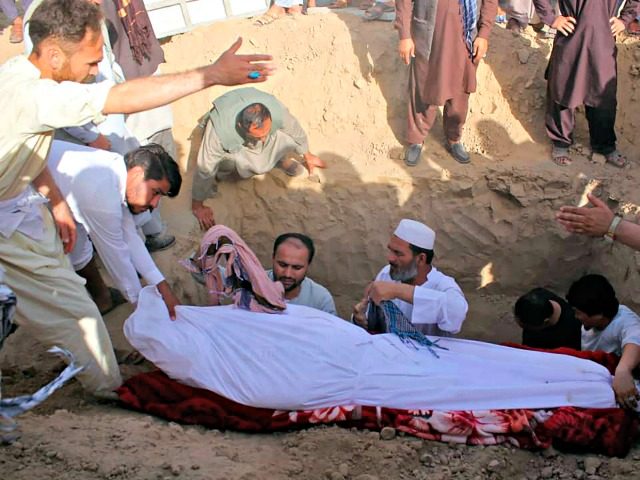 Men bury Sayed Sarwar Hussaini, the spokesperson of the Kunduz Police headquarters, who wa