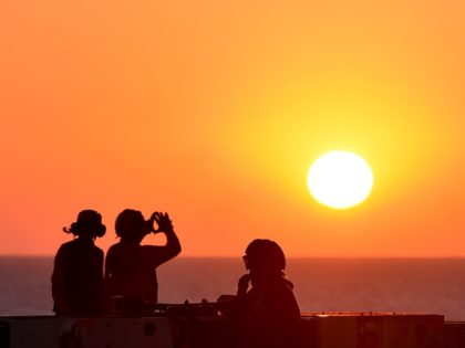 Sailors look at sunset on the US navy's super carrier USS Dwight D. Eisenhower (CVN-69) ("Ike") in the Mediterranean Sea on July 6, 2016. The US aircraft carrier is deployed in support of Operation Inherent Resolve, maritime security operations and theater security cooperation efforts in the US 6th Fleet area …