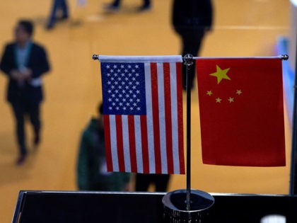 This picture taken on November 6, 2018 shows a Chinese and US flag at a booth during the f
