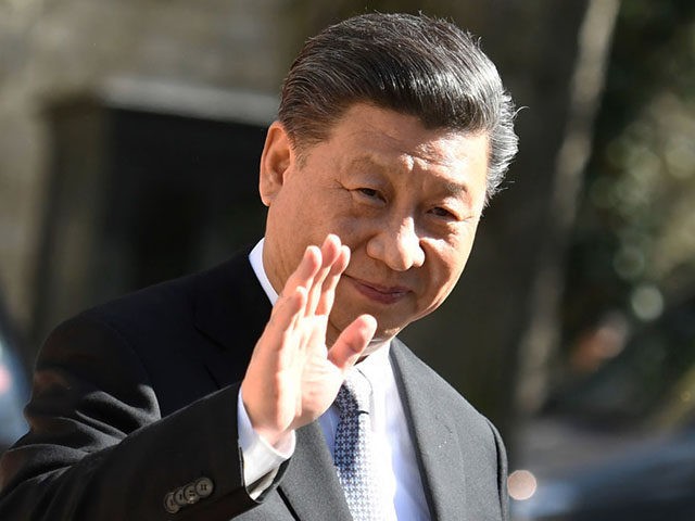 Chinese president Xi Jinping waves as he arrives for a meeting with French French Prime mi