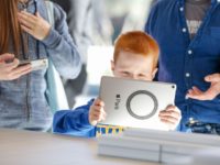 Young boy trying Apple iPad