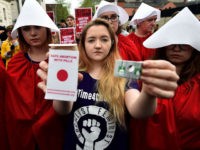 BELFAST, NORTHERN IRELAND - MAY 31: Eleanor Crossey Malone displays an abortion pill packet after taking a pill as abortion rights campaign group ROSA, Reproductive Rights Against Oppression, Sexism and Austerity distribute abortion pills from a touring bus on May 31, 2018 in Belfast, Northern Ireland. Flouting Northern Irish governmental …