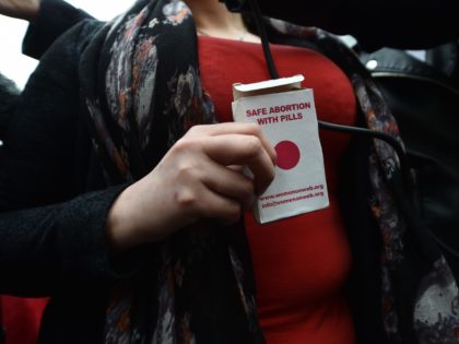 BELFAST, NORTHERN IRELAND - MAY 31: An unindentified woman displays an abortion pill packet after taking one of the pills as abortion rights campaign group ROSA, Reproductive Rights Against Oppression, Sexism and Austerity distribute abortion pills from a touring bus on May 31, 2018 in Belfast, Northern Ireland. Flouting Northern …