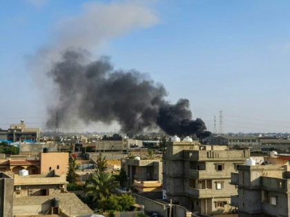 This picture taken on June 29, 2019 shows smoke plumes rising in Tajoura, south of the Libyan capital Tripoli, following a reported airstrike by forces loyal to retired general Khalifa Haftar. (Photo by Mahmud TURKIA / AFP) (Photo credit should read MAHMUD TURKIA/AFP/Getty Images)