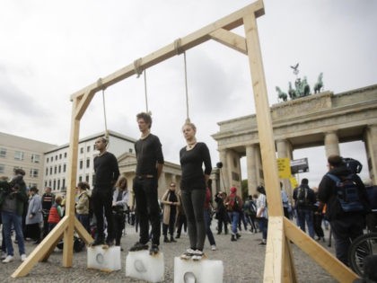 Friday MSNBC highlighted a climate change protest in front of the … Three persons stand on ice blocks under gallows to protest against the climate policy (AP Photo/Markus Schreiber)