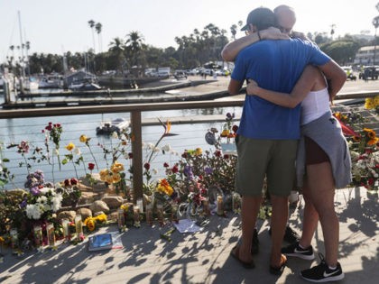 SANTA BARBARA, CALIFORNIA - SEPTEMBER 03: People embrace at Santa Barbara Harbor at a makeshift memorial for victims of the Conception boat fire on September 3, 2019 in Santa Barbara, California. Authorities have found 25 bodies thus far after the diving ship Conception caught fire and sank while anchored near …