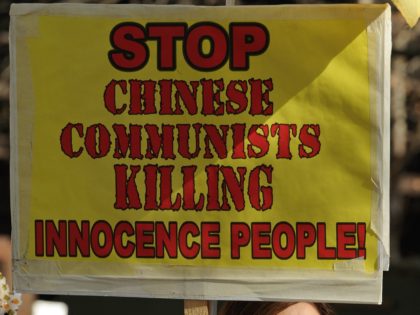 A woman holds a placard as practitioners of spiritual movement Falungong gather at Sydney'