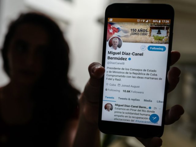 A person holds a smartphone showing the twitter account of Cuban President Miguel Diaz-Can