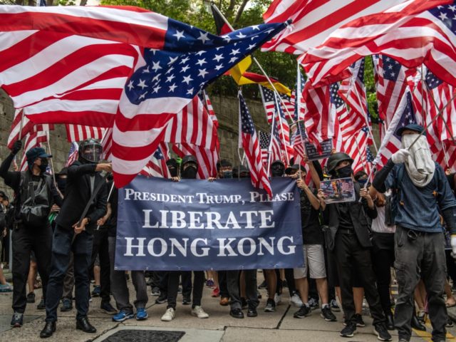 HONG KONG, CHINA - SEPTEMBER 08: Protesters wave U.S flags outside the U.S consulate after