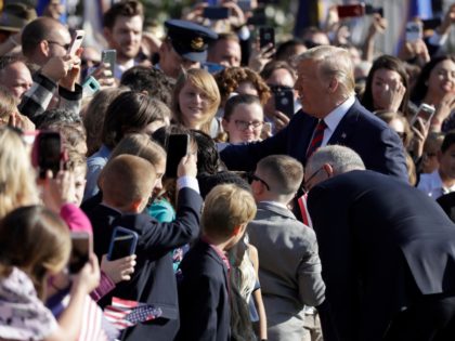 Australian Prime Minister Scott Morrison and President Donald Trump greet people during a