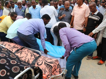 Relatives lay down on July 25, 2019 the dead body of one of Mogadishu district commissioners who was killed in a suicide bomb attack on July 24. - Six people were killed and the mayor of Mogadishu was wounded in a bombing at the mayoral offices in the Somali capital …