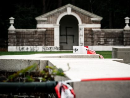 A picture taken on September 13, 2019 shows a large swastika was daubed on the inner wall of the chapel in the British World War II Commonwealth Graves cemetery in Mierlo, east of Eindhoven, Netherlands, on September 13, 2019. (Photo by Rob Engelaar / ANP / AFP) / Netherlands OUT …