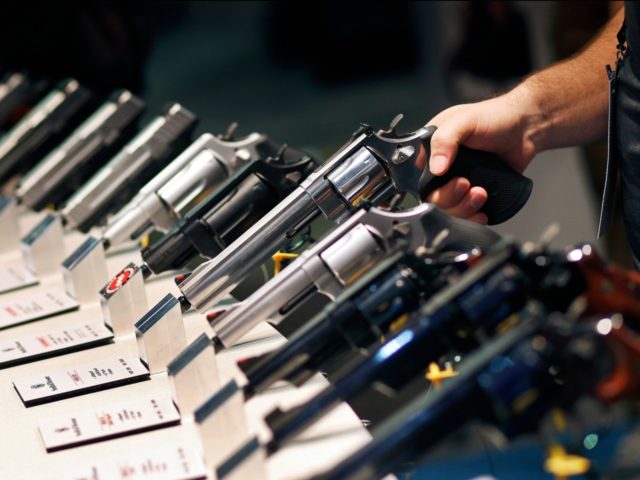 In this Jan. 19, 2016 file photo, handguns are displayed at the Smith & Wesson booth at the Shooting, Hunting and Outdoor Trade Show in Las Vegas. Backers of an expanded gun background check ballot measure approved by Nevada voters in 2016 are arguing that the Nevada governor and attorney …