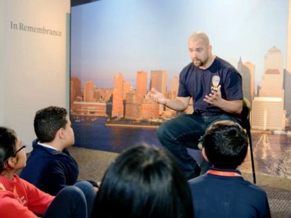 This image released by HBO shows a New York City Fireman speaking to children in a scene from the documentary "What Happened on September 11," a short film aimed at young people to explain to them what happened on Sept. 11, 2001. The program debuts on Wednesday. (HBO via AP)