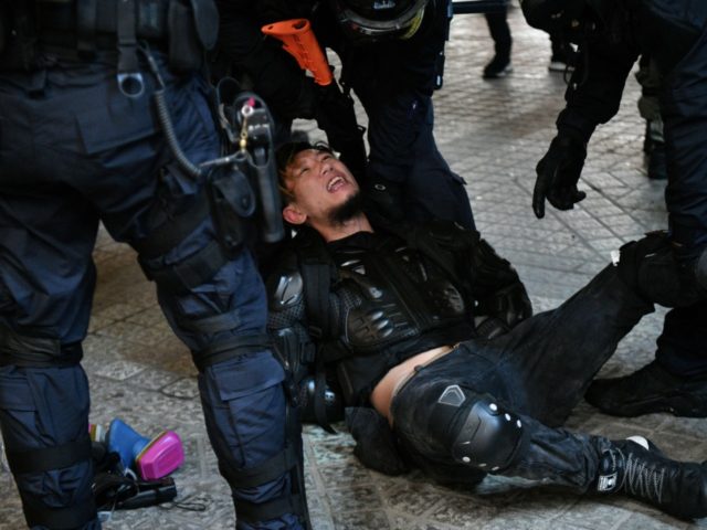 Police arrest a protester in the Causeway Bay area of Hong Kong on August 31, 2019, as peo