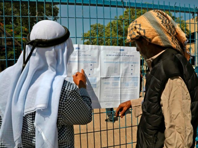Bedouins from the Negev search for their names outside a polling station in Shaqib al-Sala