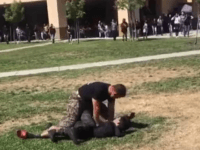 A US Marine was caught on camera brutally tackling two teenage boys to the ground in an effort to stop their fight while at their school.