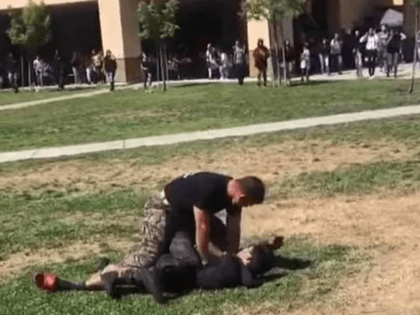 A US Marine was caught on camera brutally tackling two teenage boys to the ground in an effort to stop their fight while at their school.