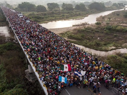 Aerial view of Honduran migrants heading in a caravan to the US, as the leave Arriaga on their way to San Pedro Tapanatepec, in southern Mexico on October 27, 2018. - Mexico on Friday announced it will offer Central American migrants medical care, education for their children and access to …
