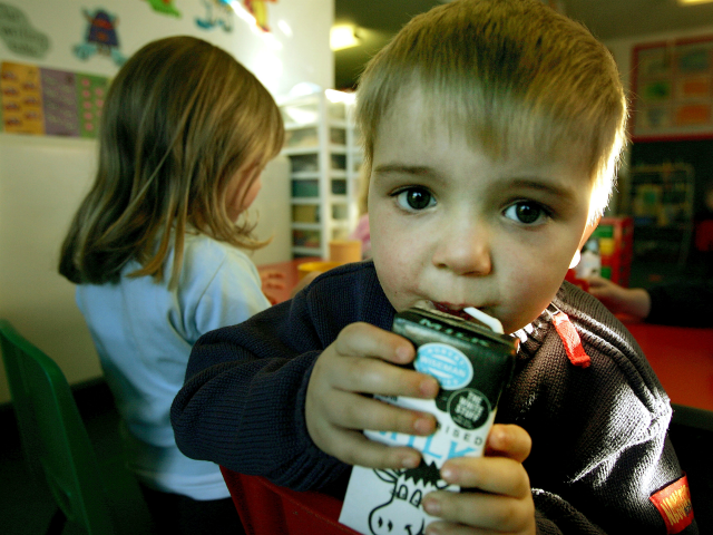 GLASGOW, SCOTLAND - JANUARY 28: A three-year-old boy drinks milk at a private nursery scho